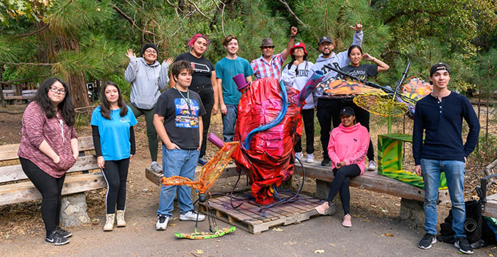 Students pose with their trash-to-art sculptures in Yosemite National Park.