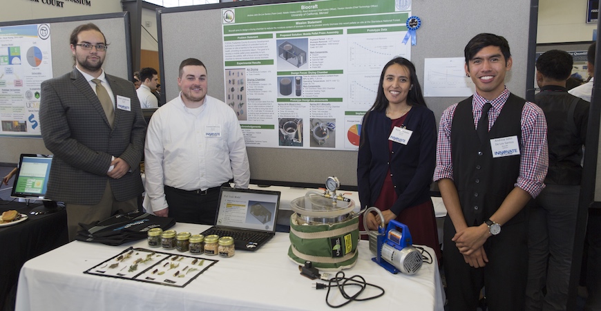 Four students stand in front of a poster explaining their Innovate to Grow capstone project.