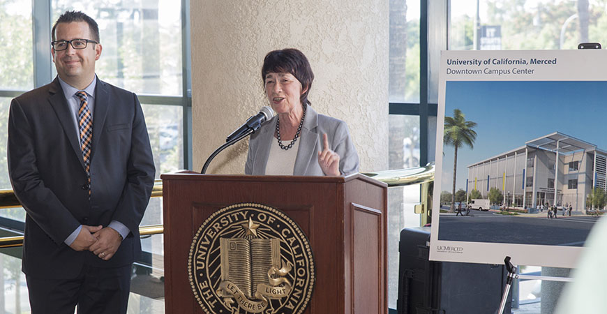 Merced Mayor Mike Murphy accompanies Chancellor Emerita Dorothy Leland at the beam signing for UC Merced's Downtown Campus Center in 2017.
