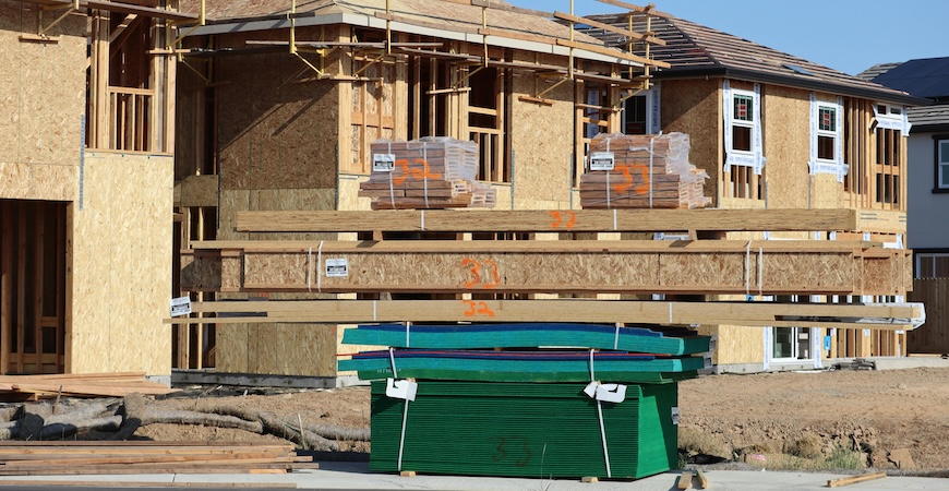 Photo depicts construction materials at a building site.