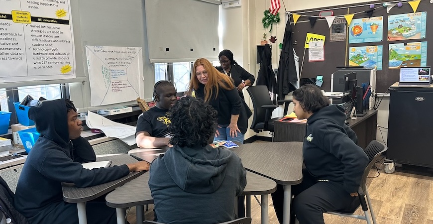 Instructor Kristen Hogue works with a class of high school students in New York City.